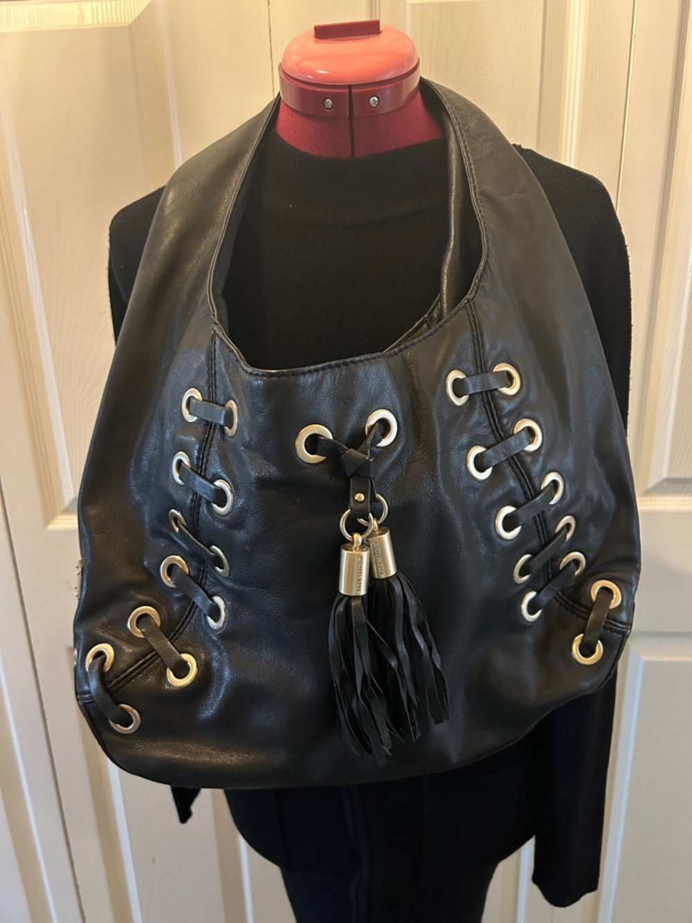 Michael Kors Black Leather Shoulder Bag with Gold Eyelets and Tassel